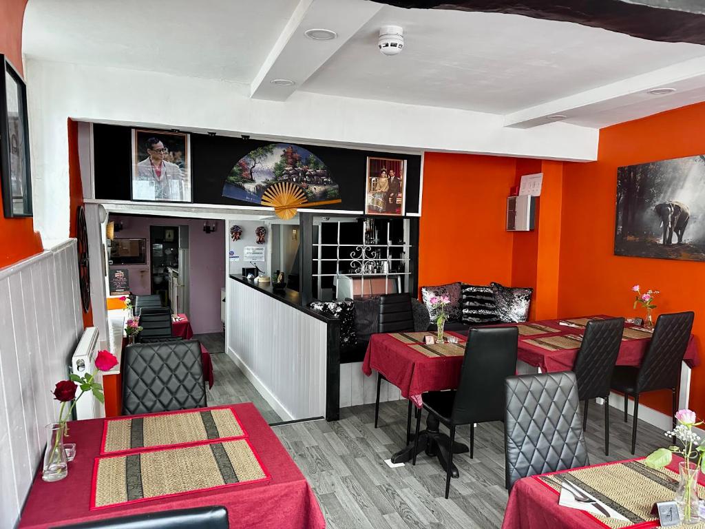 Warm interior of 36 Thai Kitchen with orange walls and Thai decor