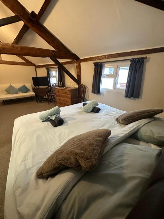 Twin beds pushed together under exposed timber beams