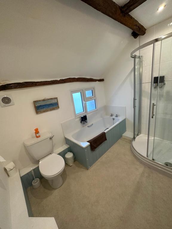 Bathroom with bath, shower and original beam