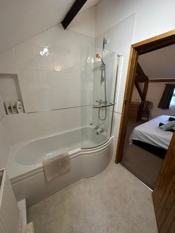 En-suite bathroom with bath and overhead shower